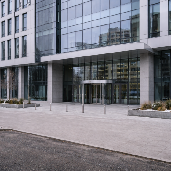 Modern bank headquarters exterior in Kyiv in winter daylight, dry pavement, no text, no flags