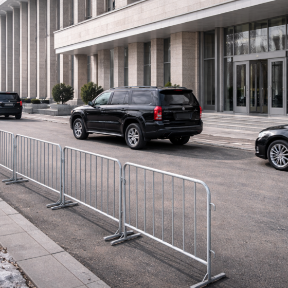 Secure perimeter outside a neutral diplomatic venue in winter daylight with unbranded vehicles and barriers, no text